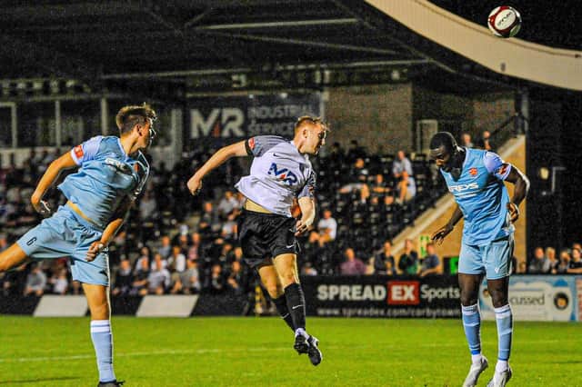 Dan Collins heads home Corby Town's equaliser in their 1-1 draw with Cambridge City at Steel Park. Pictures by Jim Darrah