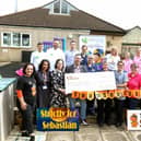 Strictly for Sebastian: Sebastian Nunney's parents Gregg and Lindsay present a cheque for £60,000 from the Strictly for Sebastian dance event organised by Lisa Tartaglia from MaSh Dance in Kettering (on left) to Disney Ward for a new outdoor area/National World