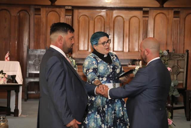 Ben and Dan with Rev Helen Wakefield-Carr officiates at the church's first same-sex wedding
