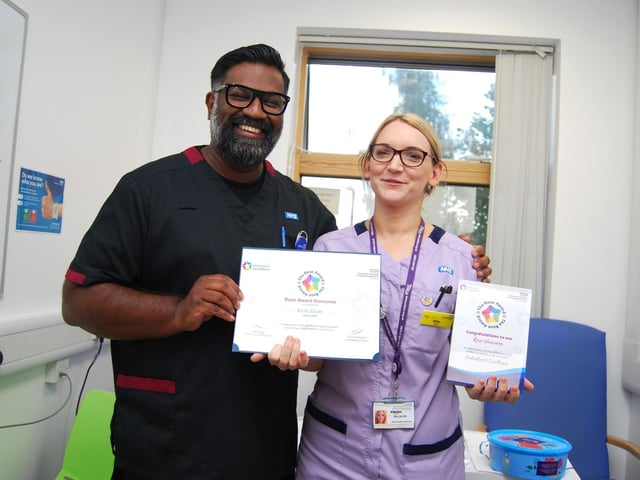 Healthcare assistant Ellie Silver is presented with her award by Prof Ganesh Baliah.