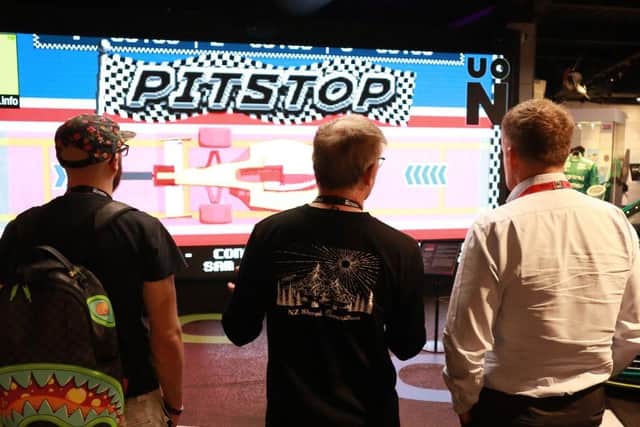 Visitors stand in front of display game at Silverstone Museum.