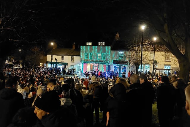 Earls Barton celebrates Christmas Eve in the Square - People gathered on the mound by the church