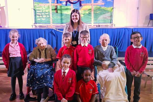 Head Teacher Sophie with the pupils of St Thomas More Catholic Primary School and the residents of Elm Bank Care Home