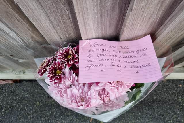 Flowers laid at the scene of a triple murder in Kettering