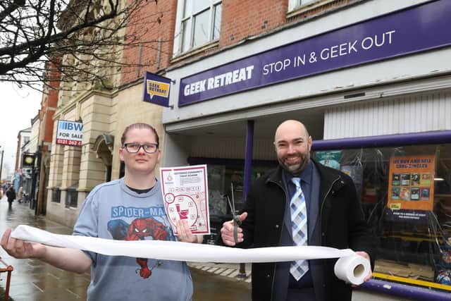 Fee Powell from Geek Retreat and Cllr Lee Watkiss leader of Kettering Town Council cutting the loo roll ribbon/National World
