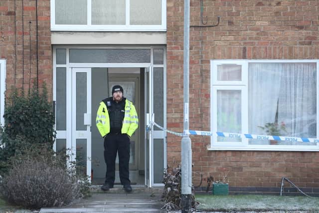 Police guard the scene in Petherton Court, Kettering