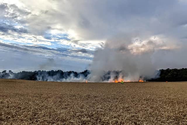 Firefighters on the scene of the fire in fields off Cranford Road, Burton Latimer