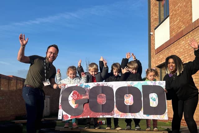 Manager Darren Mellett, staff, and children at Ashbourne Day Nurseries Pineham celebrate their 'Good' rating from Ofsted.