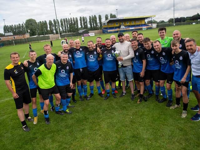 PC Jack Watts (centre, holding the trophy) with members of the victorious NorPol football team