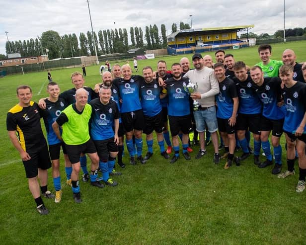 PC Jack Watts (centre, holding the trophy) with members of the victorious NorPol football team