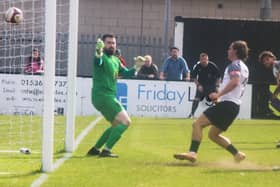 Connor Tomlinson slots home his second goal in Corby Town's 7-1 thrashing of Sporting Khalsa on Saturday (Picture: David Tilley)