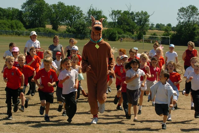 Raunds, Sport Relief event. At Manor School. St Peter's Junior School pupils running with Scooby Doo- Matthew Phillpot, 15, from Manor School.
July 2006
