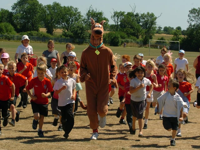 Raunds, Sport Relief event. At Manor School. St Peter's Junior School pupils running with Scooby Doo- Matthew Phillpot, 15, from Manor School.
July 2006