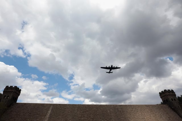 A Lancaster bomber flies over Ladybower reservoir in the Derbyshire Peak District to mark the 70th anniversary of the World War II Dambusters mission on in Derwent, England. Ladybower and Derwent reservoirs were used by the RAF's 617 Squadron in 1943 to test Sir Barnes Wallis' bouncing bomb before their mission to destroy dams in Germany's Ruhr Valley. Today marks the 70th anniversary of the famous Dambuster mission and will be watched by veterans from the original campaign.  (Photo by Christopher Furlong/Getty Images)