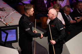 Kyren Wilson shakes hands with John Higgins after the Kettering man was well beaten in the second round of the Cazoo World Championship