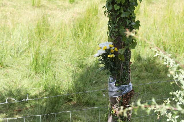 Flowers have been attached to a tree near to the scene on the A427 Corby to Market Harborough road.