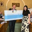 Cllr Paul Byrne presenting one of the two cheques to his chosen charities