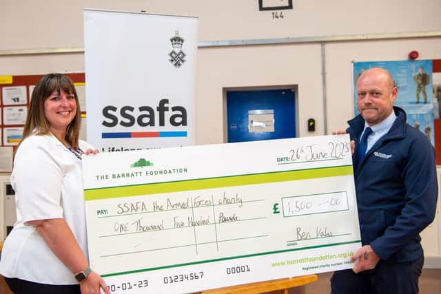 Gayle from SSAFA receiving her cheque from Dean from David Wilson Homes