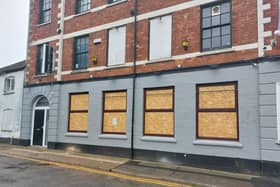 A notice has been posted on the venue's boarded-up windows