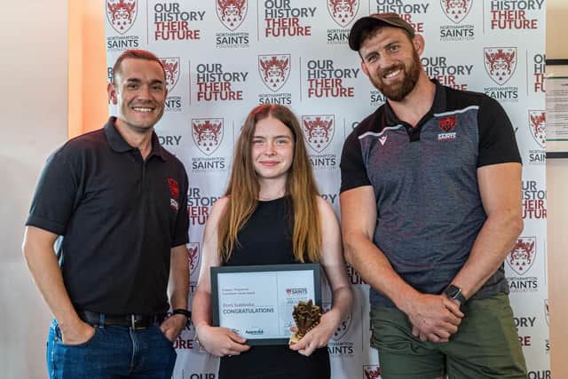 Domi Szablinska receives her Foundation Values award from the Foundation’s Employability Lead, Craig Philips and ambassador, former Saints player, Tom Wood.