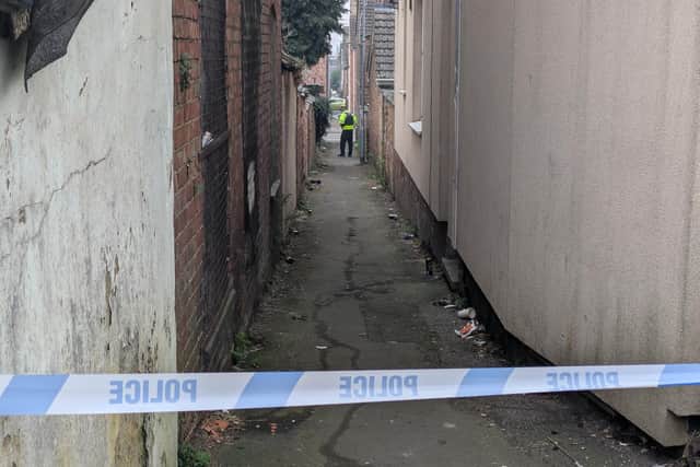 The alleyway parallel to Newcomen Road remains closed by police as of this morning