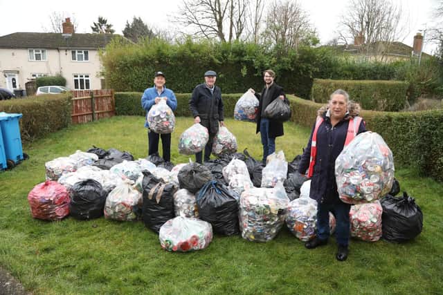 Tinker Williams founder of the Kettering Wombles with the aluminium cans collected in one month  L-r Derek Bradshaw (resident), John Nowell (Helipads for Hospitals), Ben Williams Kettering Greens.