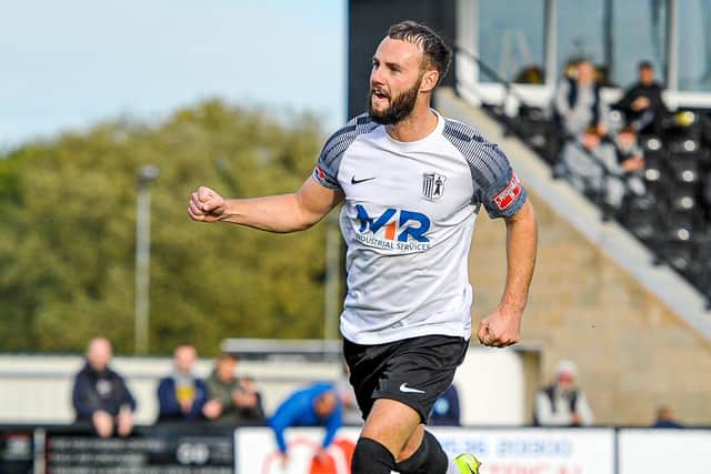 Curtis Burrows heads off to celebrate after he made it 2-0 from the penalty spot