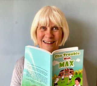 Marjorie, reading her first published book, 'The Trouble With Max'
