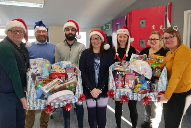 Peparing presents for delivery to children spending Christmas at Northampton General Hospital and Kettering General Hospital are the team at Matthew Oliver Windows & Doors