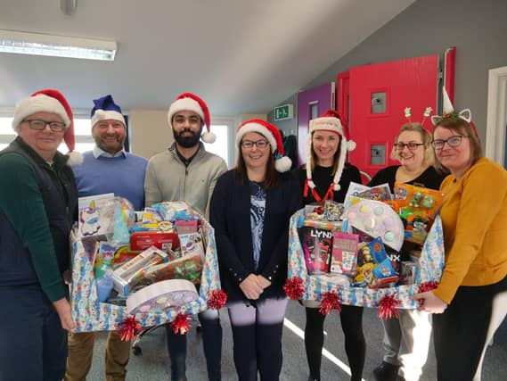 Peparing presents for delivery to children spending Christmas at Northampton General Hospital and Kettering General Hospital are the team at Matthew Oliver Windows & Doors