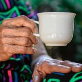 Elderly lady with a cup of tea.