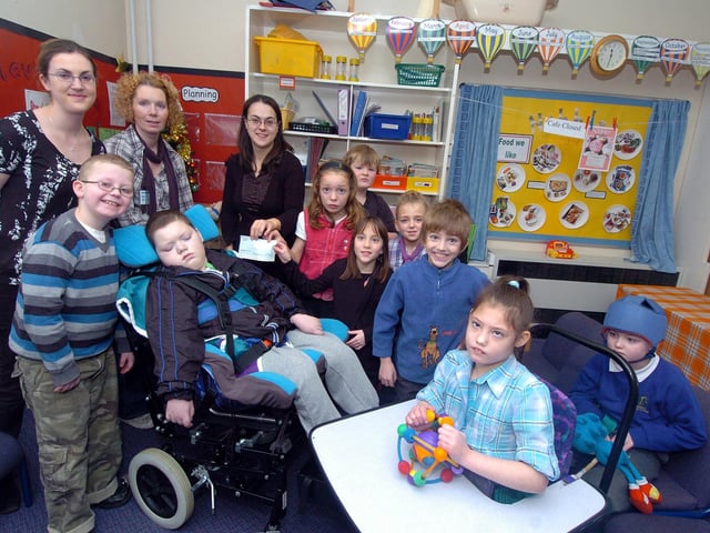 Corby, Beanfield Primary School, DSP Unit, £800 given by former pupil and family to his former classmates and teachers. Owl Class with Christopher Hoey, 11, and mum Trisha December 2010