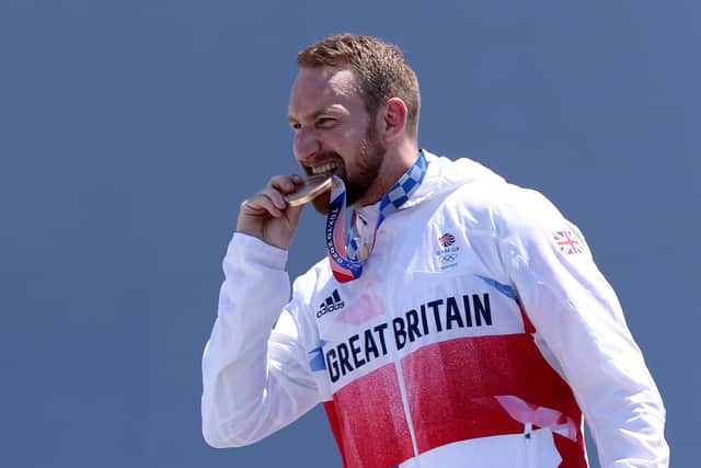 Bronze Medalist Declan Brooks of Team Great Britain bites his medal on the podium after the Men's Park Final of the BMX Freestyle on day nine of the Tokyo 2020 Olympic Games at Ariake Urban Sports Park on August 01, 2021 in Tokyo, Japan. (Photo by Jamie Squire/Getty Images)