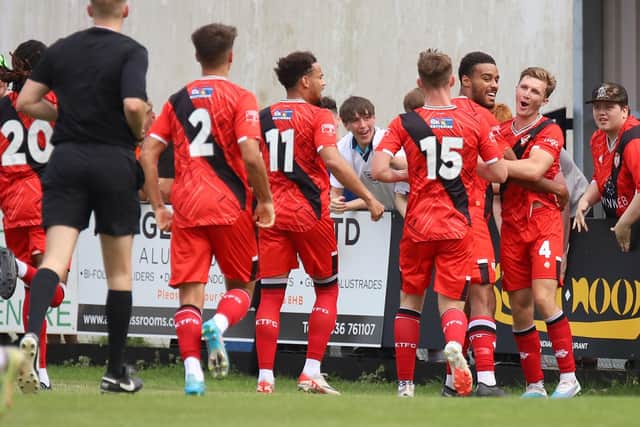 Harry Reilly is mobbed by his team-mates after scoring the only goal of the game for Kettering Town (Picture: Peter Short)
