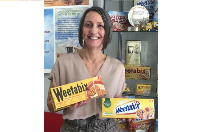 Lynn Furnival, one of Weetabix’s longest standing employees with a Weetabix Original box from the 1960s, alongside a present day box