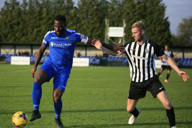 Corby Town captain Gary Mulligan challenges Dunstable Town's Arel Amu during the 3-3 draw at the weekend