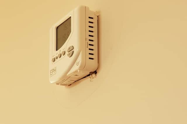 The wall behind the thermostat hadn't been filled in properly
