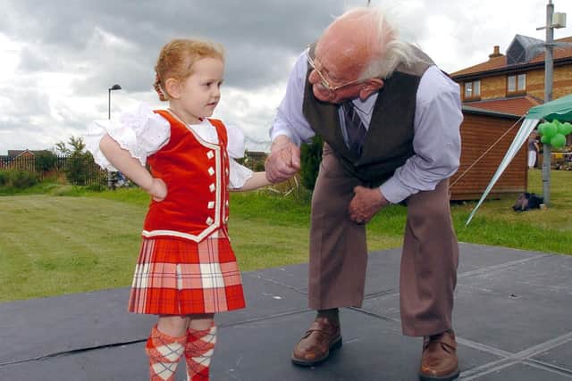Getting a Scottish dancing lesson from Debony Richardson, then four, in 2008