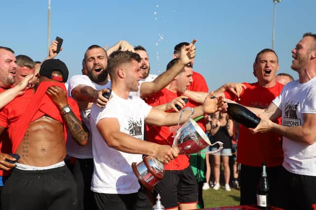 Kettering Town's players enjoy their title party