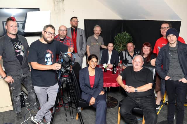 Director Jason Impey (leaning on the camera) with some of the cast and crew