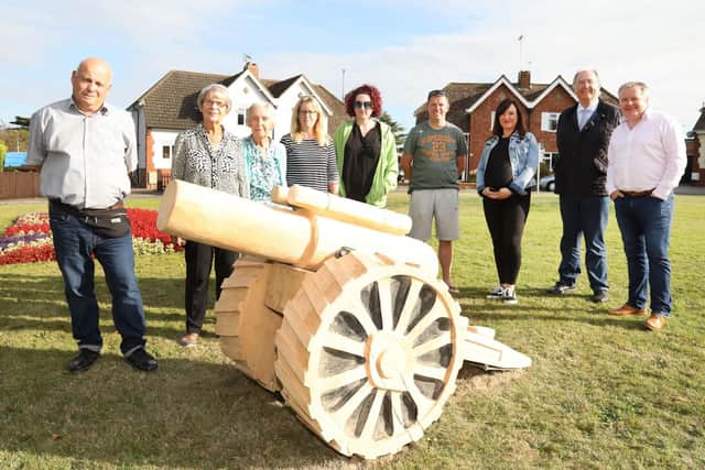 Members of Kettering Council with Legion Crescent residents and the carved cannon. Pictures by Alison Bagley.