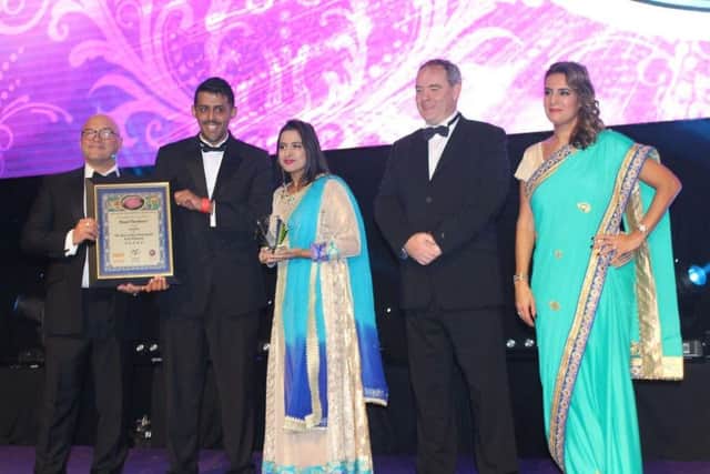 Owner Mohammed Hussain with his sister Aleya Shahjid receiving the award from MasterChef presenter Greg Wallace. NNL-171127-101758005