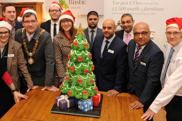 Front left to right: Caz Clarke - Cake Artist; Kerri Beckett -store manager Oak Furniture Land Kettering; Mayor of Kettering - Councillor Scott Edwards; Maxine Andrews - Fundraiser Kettering General Hospital Charity Fund; surrounded by the new store team