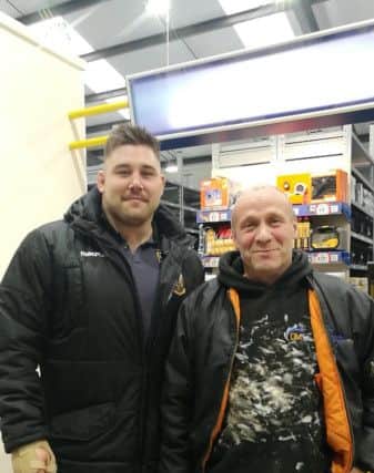Kieran with a customer at the opening. NNL-171129-115415005
