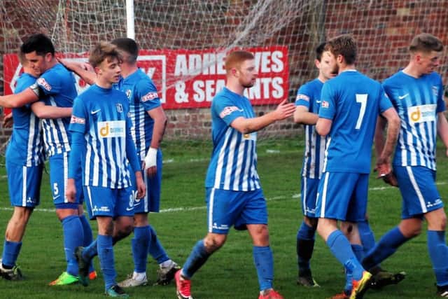 Corby Town celebrate the first of Jordon Crawfords three goals as he bagged a hat-trick in the 4-1 victory at Gresley FC last weekend. Picture by David Tilley