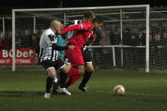 Rene Howe takes on a couple of St Ives defenders