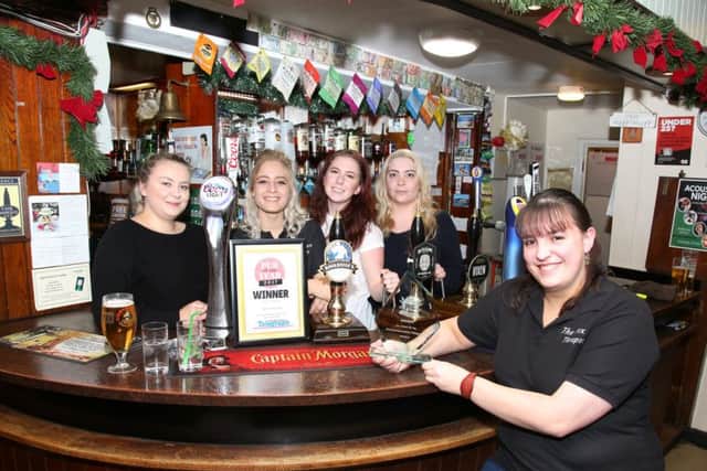 Landlady Katie Buncombe with the bar staff celebrating their win as the Northants Telegraph Pub of the Year