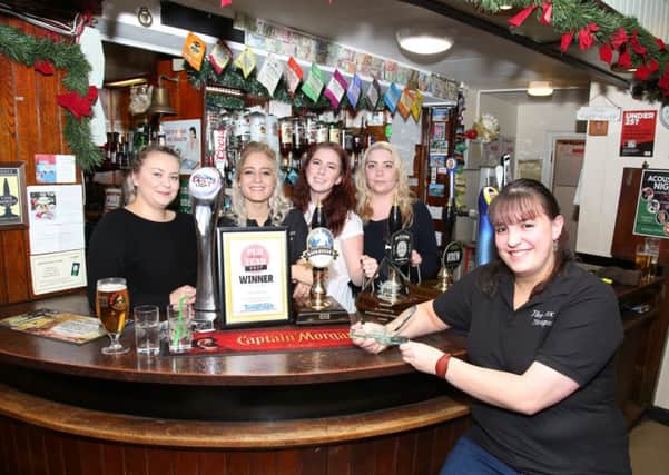 Landlady Katie Buncombe with the bar staff celebrating their win as the Northants Telegraph Pub of the Year