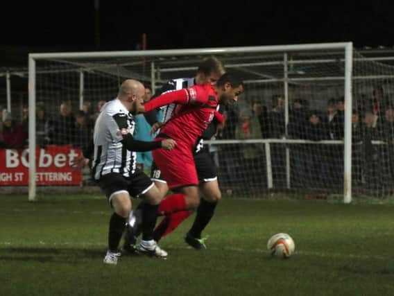 Rene Howe takes on two St Ives Town defenders during Kettering Town's 4-1 home success on Tuesday night. Picture by Peter Short