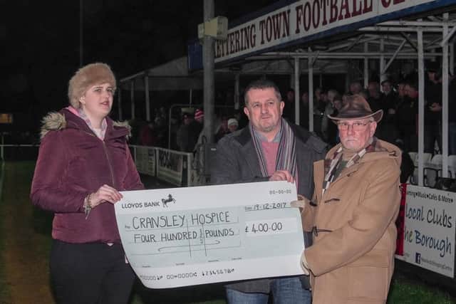 Cransley Hospice volunteer Yaiza Conde receives a cheque from Dave Rose of the Kettering Civic Society along with artist Len Litchfield. Picture by Barry Medlock